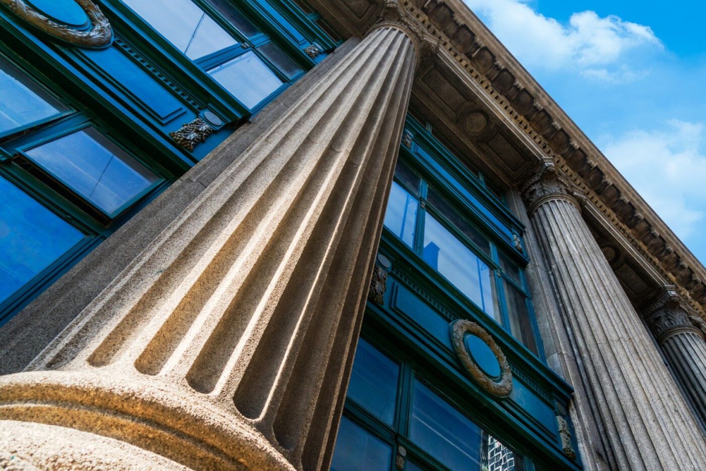 an image of stone columns and vintage windows on a historic building facade.